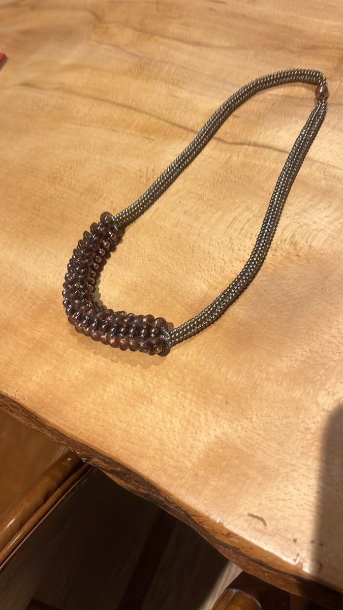 Beaded rope necklace with a cluster of bronze beads, finished at a bead afternoon
