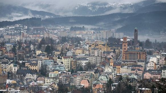 Jablonec nad Nisou from Hotel Petřín: rooftops, 1930s town-hall tower, hills and reservoir
