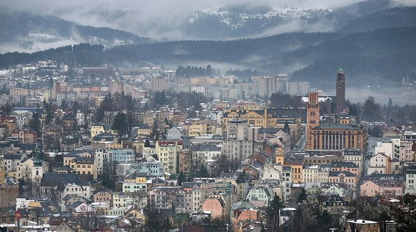 Jablonec nad Nisou from Hotel Petřín: rooftops, 1930s town-hall tower, hills and reservoir