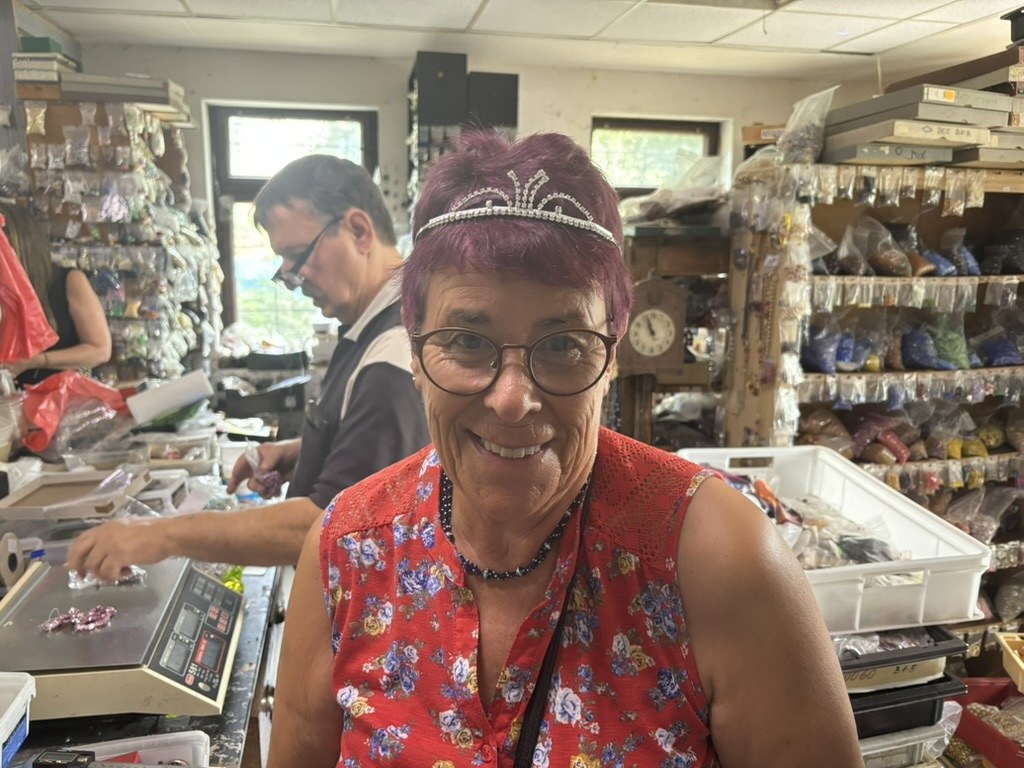 Hilary wearing a tiara in an antique bead shop