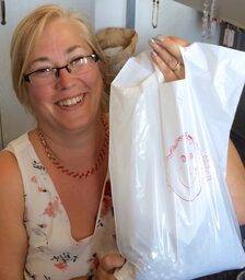 A happy tour guest holding her bag of Czech glass beads