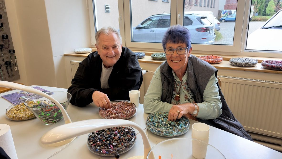 Couple choosing beads together at a table