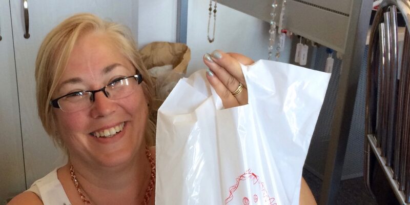 A happy tour guest holding her bag of Czech glass beads