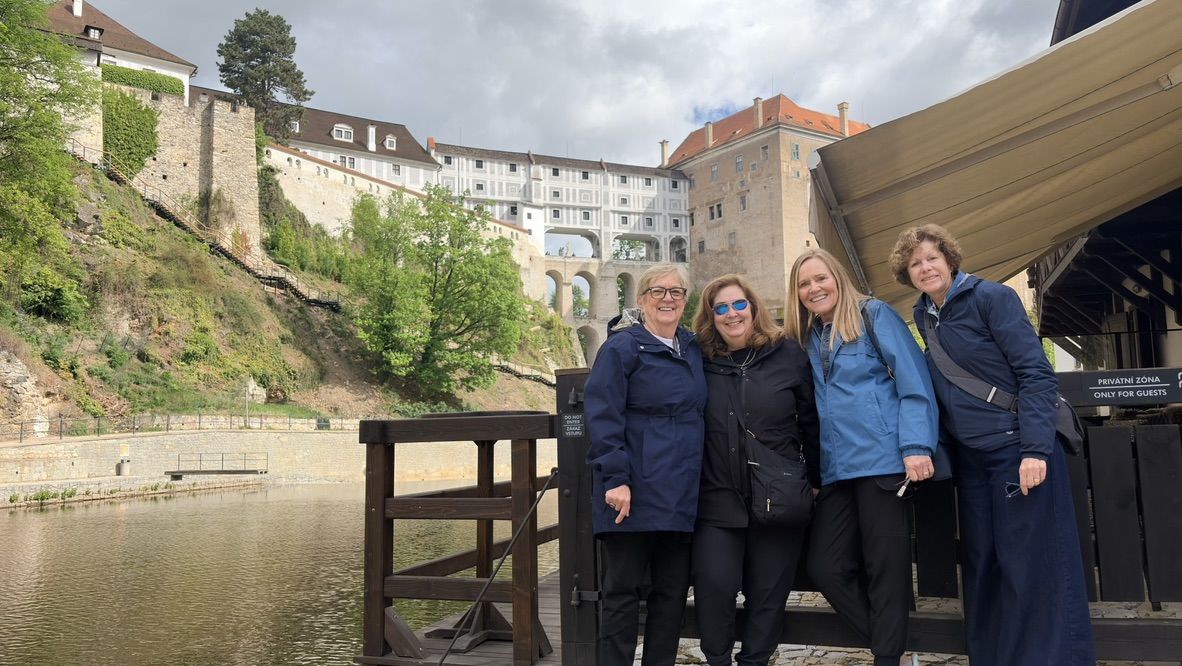 Tour group in Český Krumlov with the castle behind them
